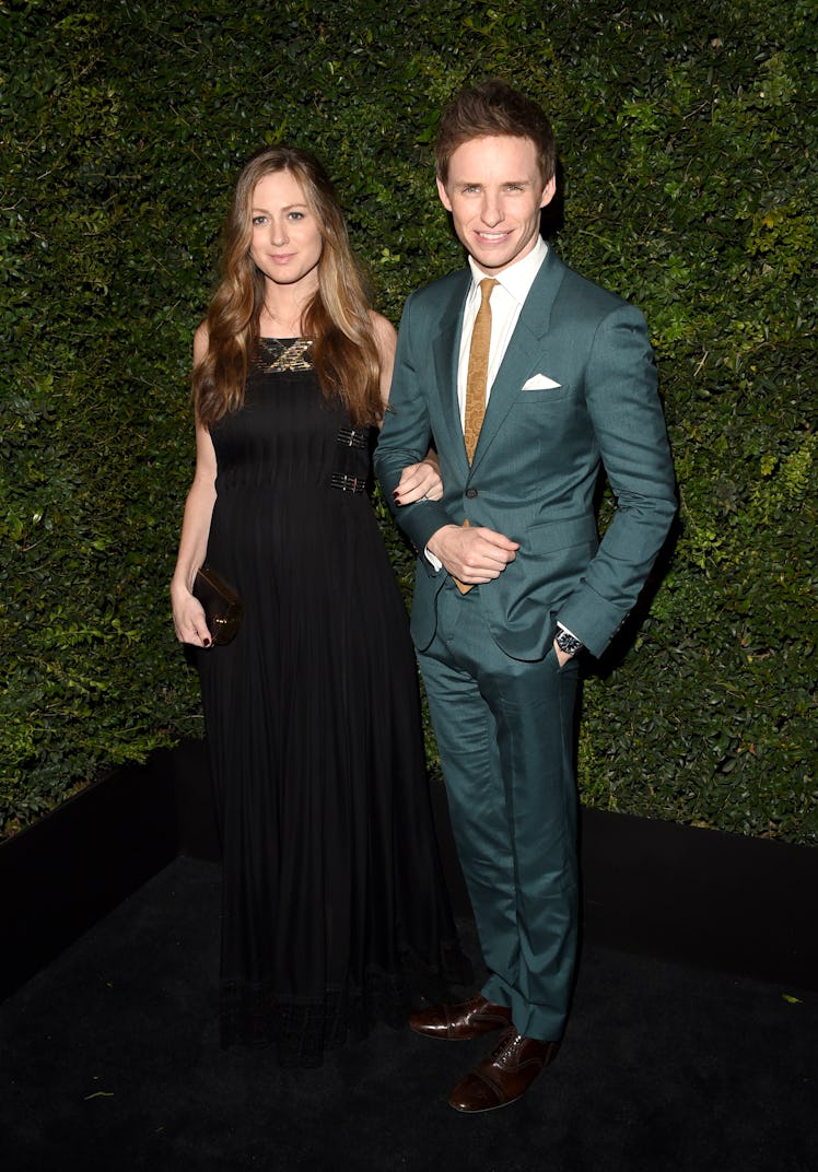 Hanah Bagshawe in a black dress and Eddie Redmayne in a teal suit at Chanel’s Pre-Oscars Dinner