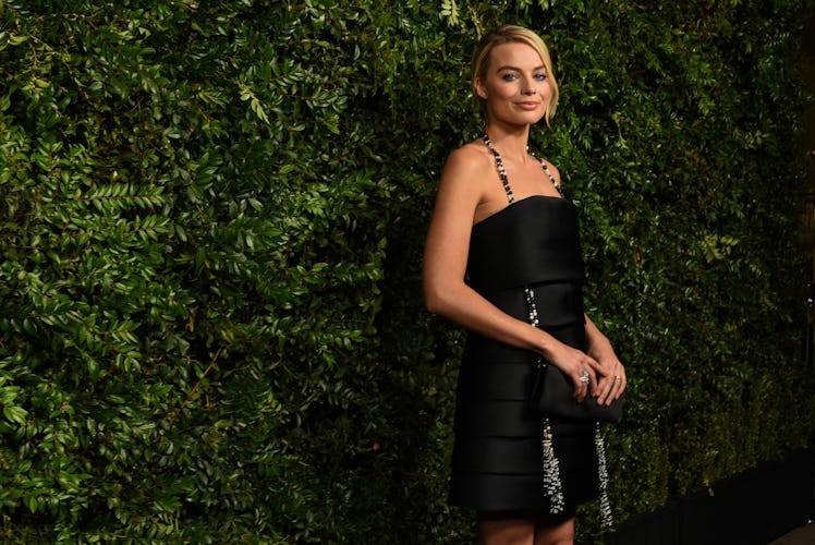 Margot Robbie in a black dress at Chanel’s Pre-Oscars Dinner