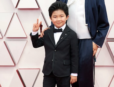 Alan Kim flashing a peace sign on the Oscars red carpet