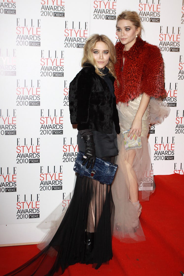 Mary-Kate and Ashley Olsen in a black and pink-red outfits by Alber Elbaz