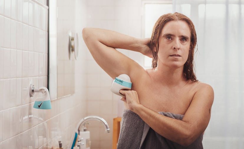 Image of woman using Degree Inclusive deodorant.