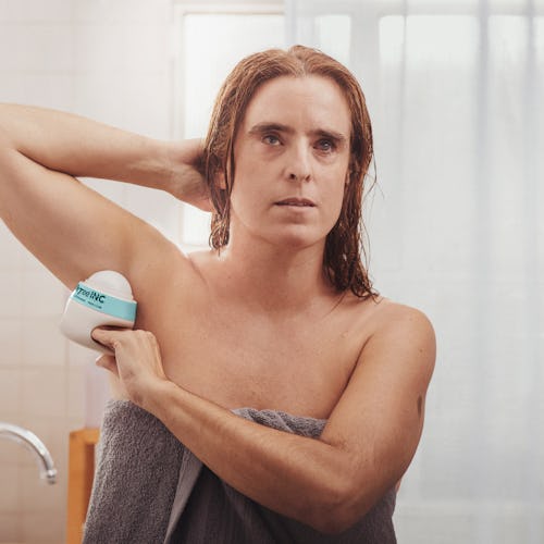 Image of woman using Degree Inclusive deodorant.