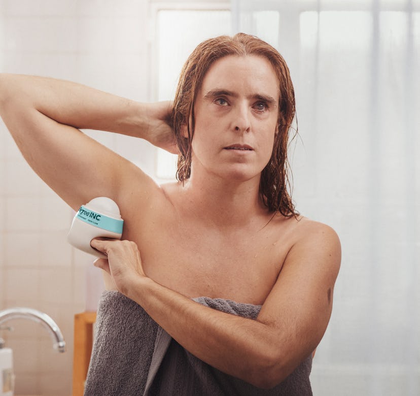 Image of woman using Degree Inclusive deodorant.