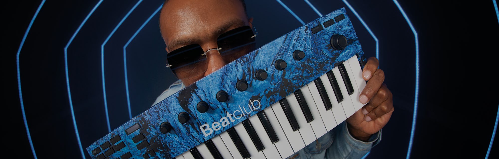 Timbaland holds a molten blue Native Instruments M32 keyboard.