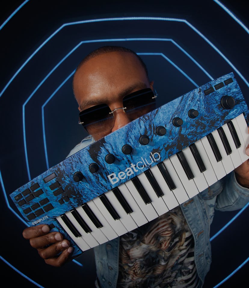 Timbaland holds a molten blue Native Instruments M32 keyboard.