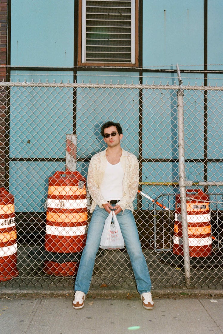 Eli Brown in white tank and jeans