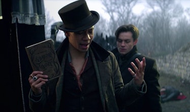 Kit Young as Jesper holding a copy of Shadow and Bone in Shadow and Bone