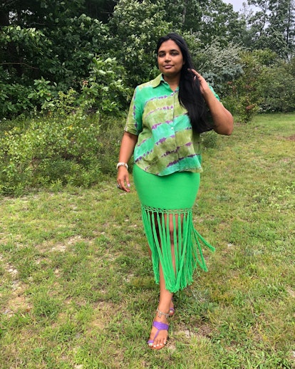 Sheena Sood in a green dress outside