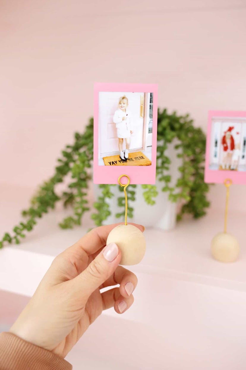 DIY place card holders holding up family pictures is a great DIY mother's day gift idea