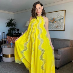 Gal Gadot wearing a yellow Stella McCartney dress paired with Dries van Noten heels, photographed by...