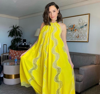 Gal Gadot wearing a yellow Stella McCartney dress paired with Dries van Noten heels, photographed by...
