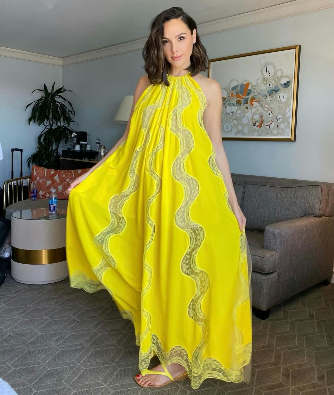 Gal Gadot wearing a yellow Stella McCartney dress paired with Dries van Noten heels, photographed by...