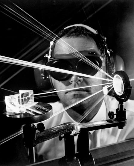 Man using a Lyma Laser while wearing ear and eye protectors.