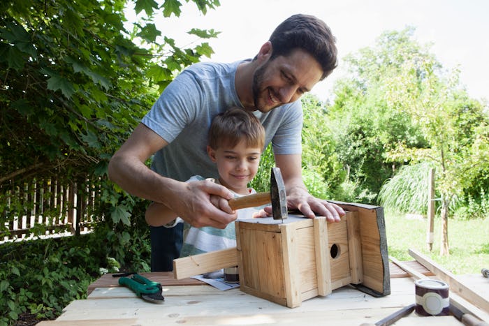 Dad and son making homemade bird house, a great DIY mother's day gift