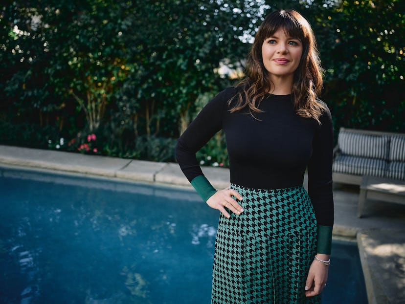Casey Wilson posing by a pool