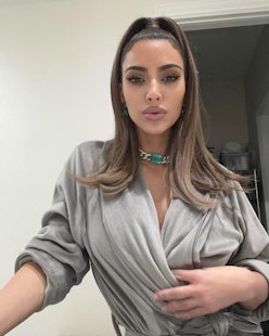 a selfie of kim kardashian wearing a gray robe