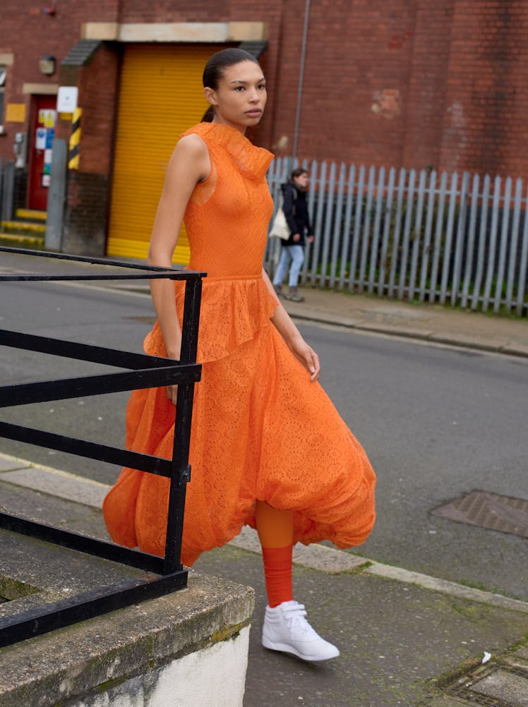 Ava Akilu wears a JW Anderson dress; Calzedonia tights; Charvet socks; Reebok sneakers (throughout).