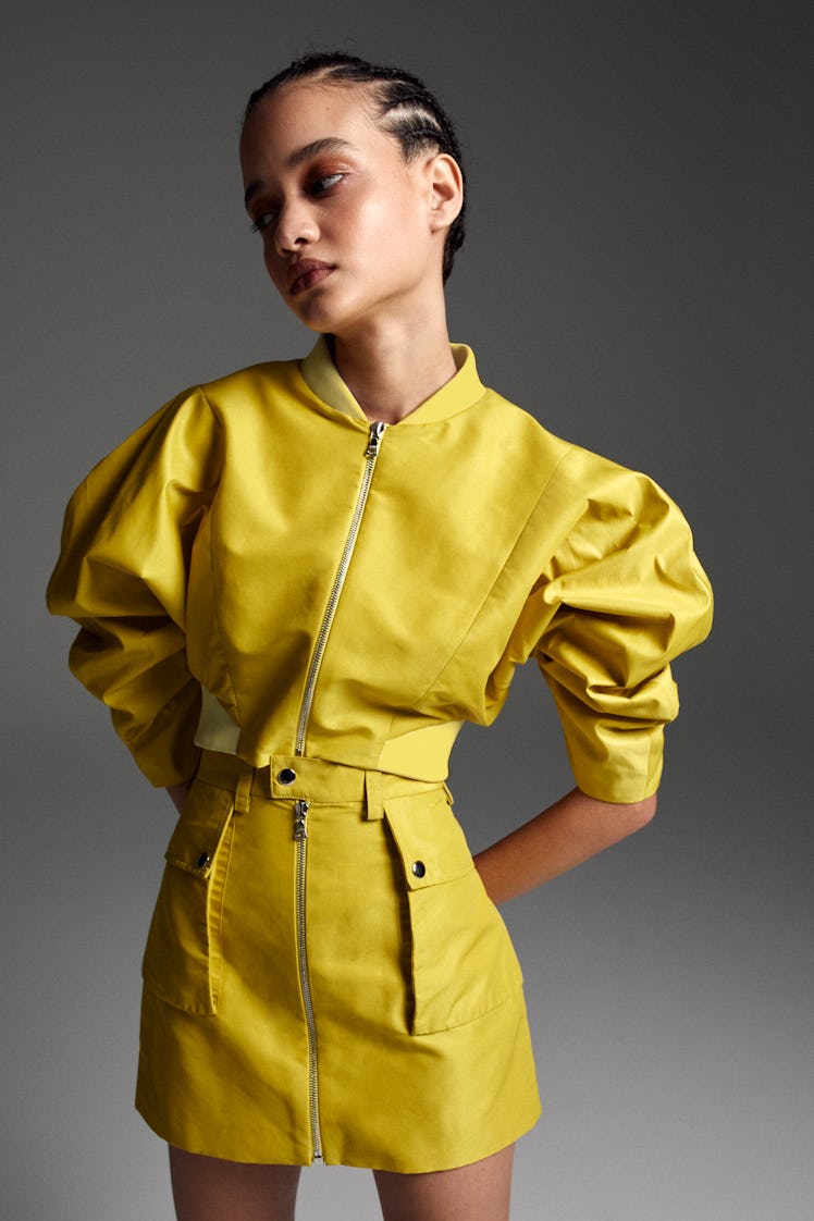 A model in a yellow jacket and skirt by Aliétte