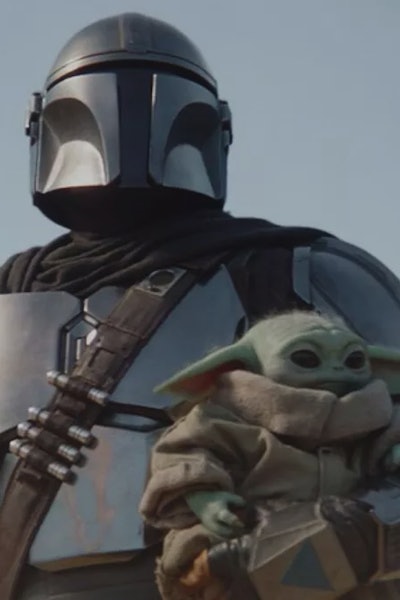 Pedro Pascal as Mando holding baby Yoda 