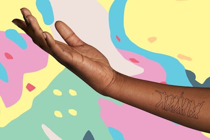 An outstretched arm is adorned in a BTS x Inkbox temporary tattoo that features the silhouette of se...