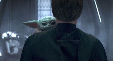 An unknown character showed from the back while holding Baby Yoda in his arms