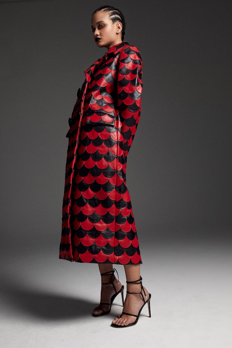 A model in an Aliétte checkered black and red coat