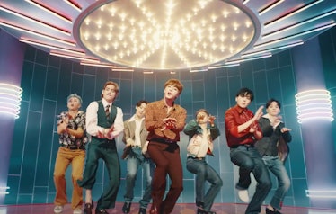 The members of BTS dance in the music video for "Dynamite."