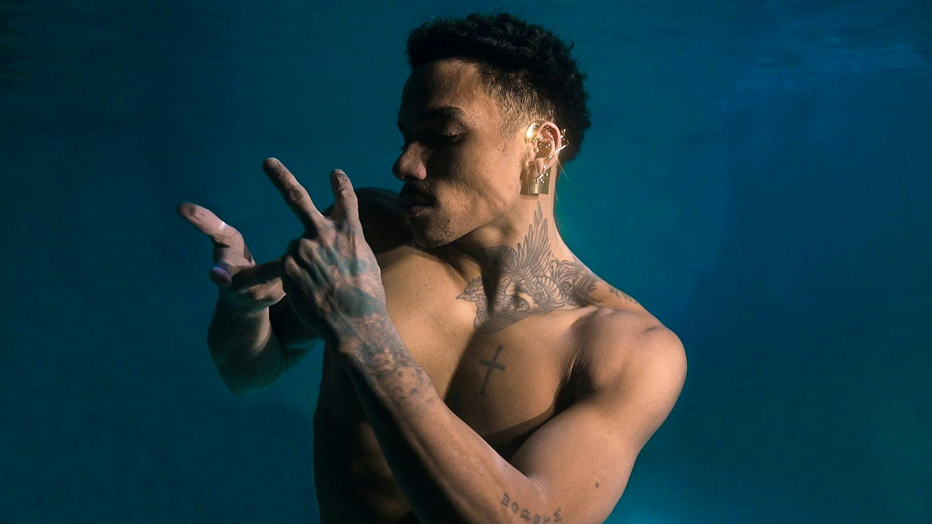 A model is seen gesturing with an ear jewel piece on.