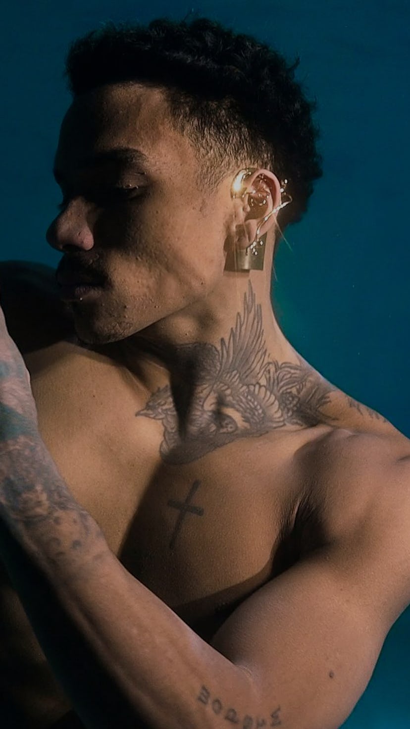 A model is seen gesturing with an ear jewel piece on.