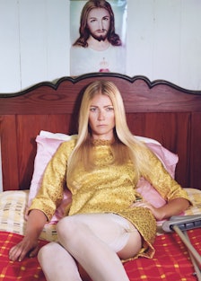 Gwyneth Paltrow in bed under a Jesus portrait