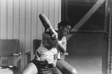 A person combing a child's hair