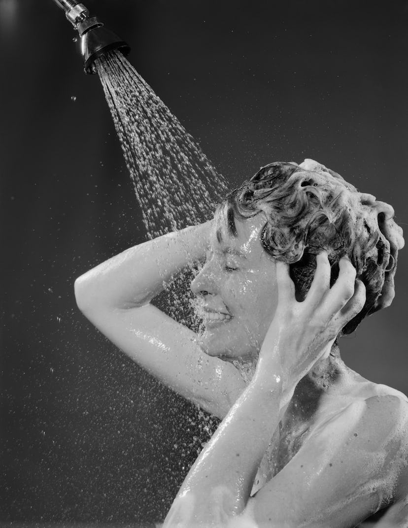 A woman washing her hair with haircare products from the Ulta sale's.