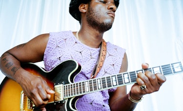 Leon Bridges wears a Bode top;  his own hat and jewelry. 