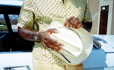 Leon Bridges wears Bode shirt;  his own hat and jewelry.