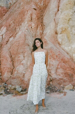 Model wears wedding guest dress from Coco Shop.