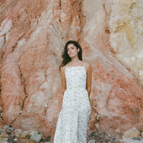 Model wears wedding guest dress from Coco Shop.