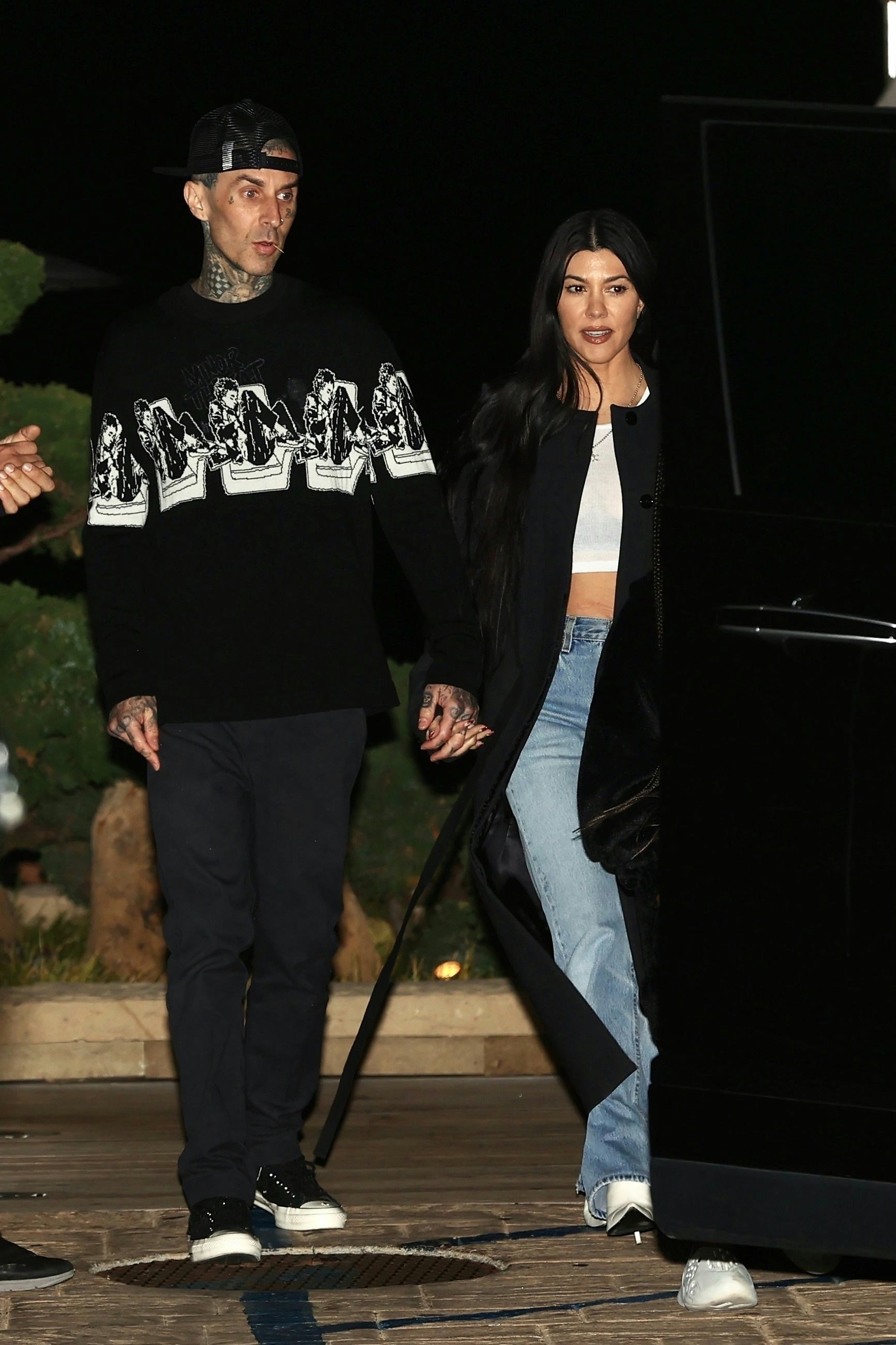 From vintage-inspired tops to open flannel shirts, see Kourtney Kardashian & Travis Barker's best ‘9...