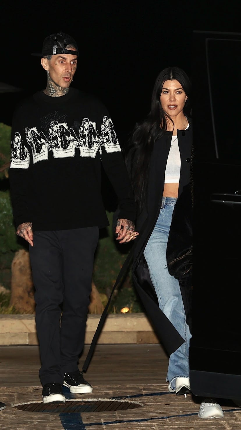 From vintage-inspired tops to open flannel shirts, see Kourtney Kardashian & Travis Barker's best ‘9...