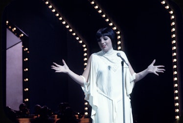 Liza wears all white gown