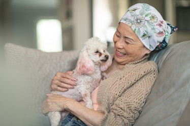 Woman with cancer relaxes with dog