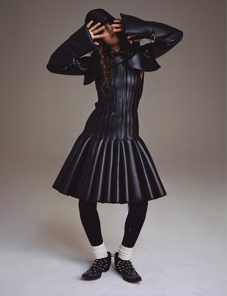 Model Deba Hekmat wears a Robert Wun hoodie, dress, and hat; Comme des Garçons tights; Gucci socks; ...