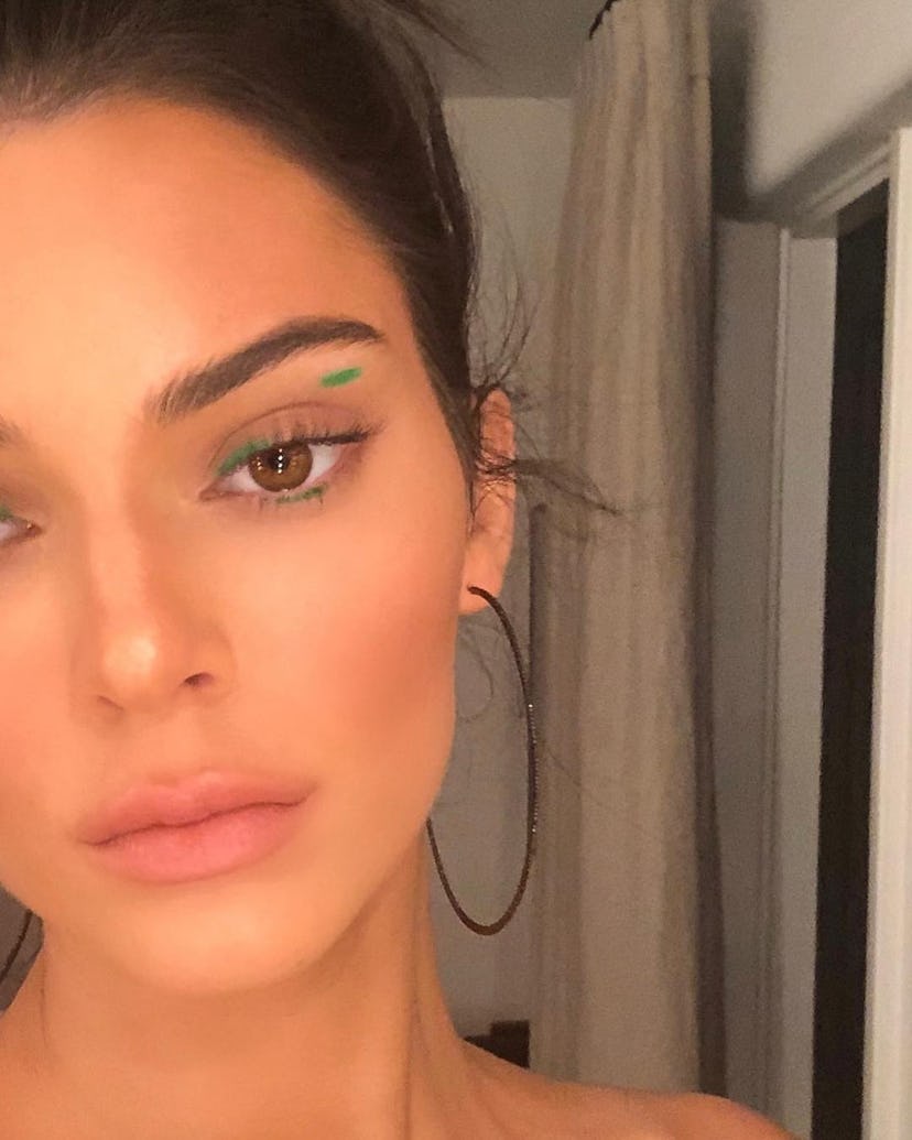 Kendall Jenner wearing green graphic eyeliner.