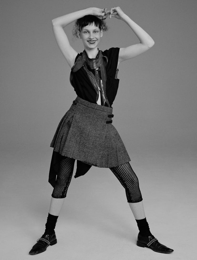 Model Tayla Jade wears a Dior bralette, skirt,  and fishnet leggings; vintage Comme des Garçons dres...