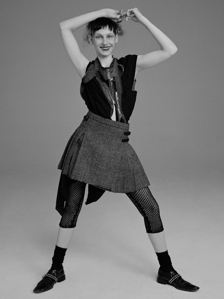 Model Tayla Jade wears a Dior bralette, skirt,  and fishnet leggings; vintage Comme des Garçons dres...