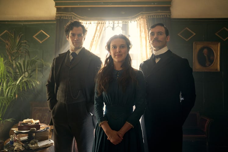 Millie Bobby Brown as Enola Holmes, Henry Cavill as Sherlock Holmes, and Sam Claflin as Mycroft Holm...