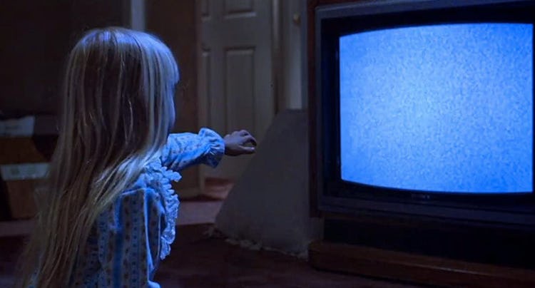 Heather O'Rourke reaching towards tv with static for Poltergeist