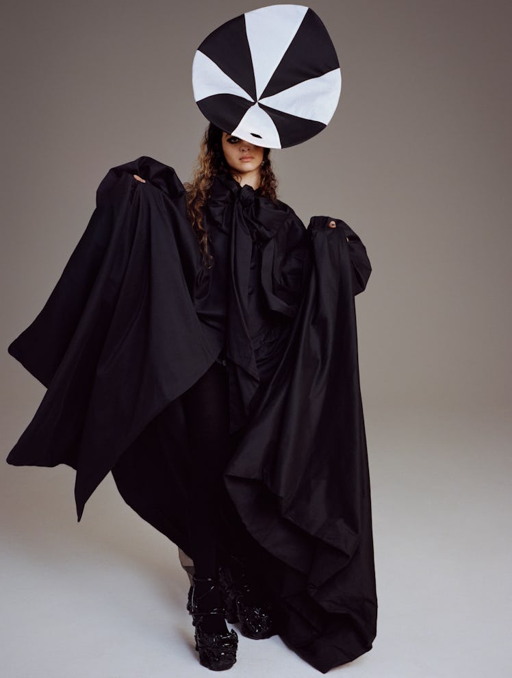 Deba Hekmat wears a Connor Baxter gown and headpiece; Comme des Garçons tights; Del Core shoes.