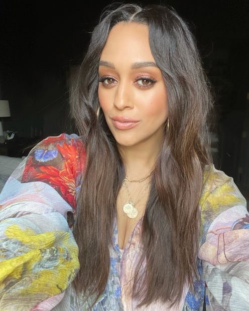 a selfie of tia mowry with dark brown wavy hair and orange eye makeup