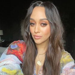 a selfie of tia mowry with dark brown wavy hair and orange eye makeup