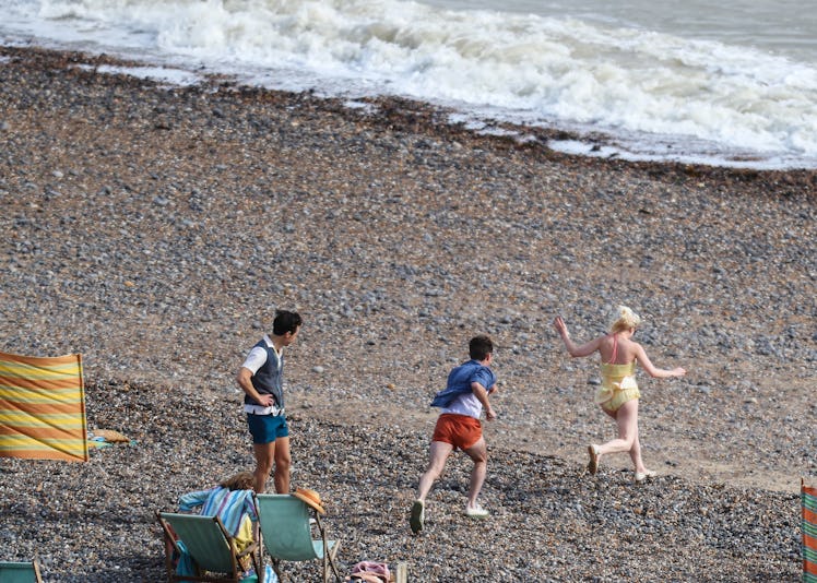 Harry Styles on the beach with fellow My Policeman cast members